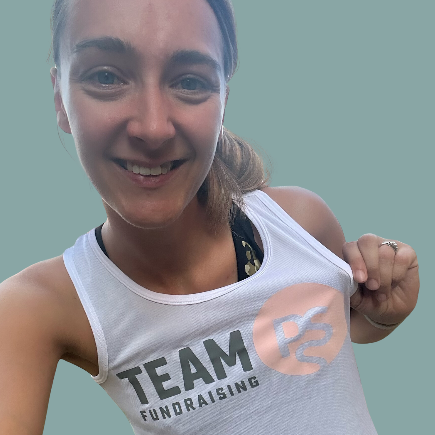 Volunteering for PSS Woman holding her fundraising shirt smiling